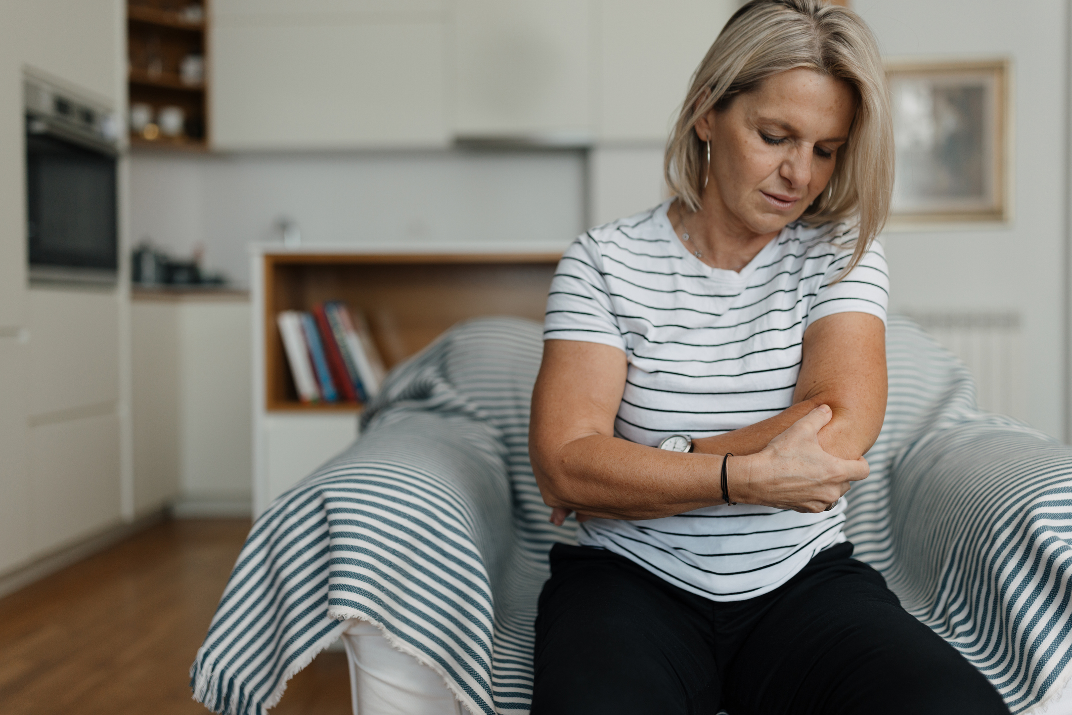Person with elbow pain requiring specialized chiropractic treatment in Salinas