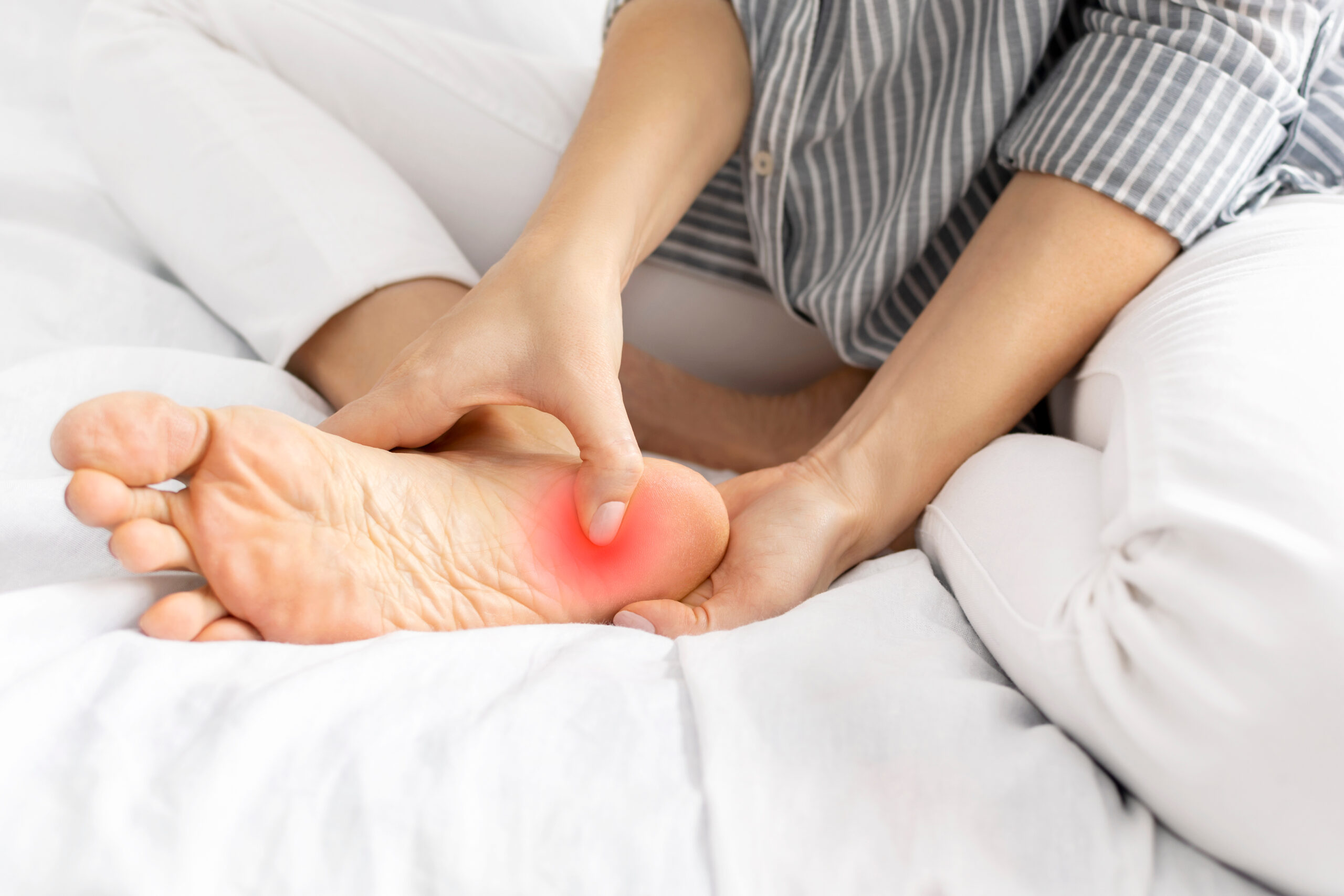 Person with plantar fasciitis foot pain needing specialized treatment in Salinas