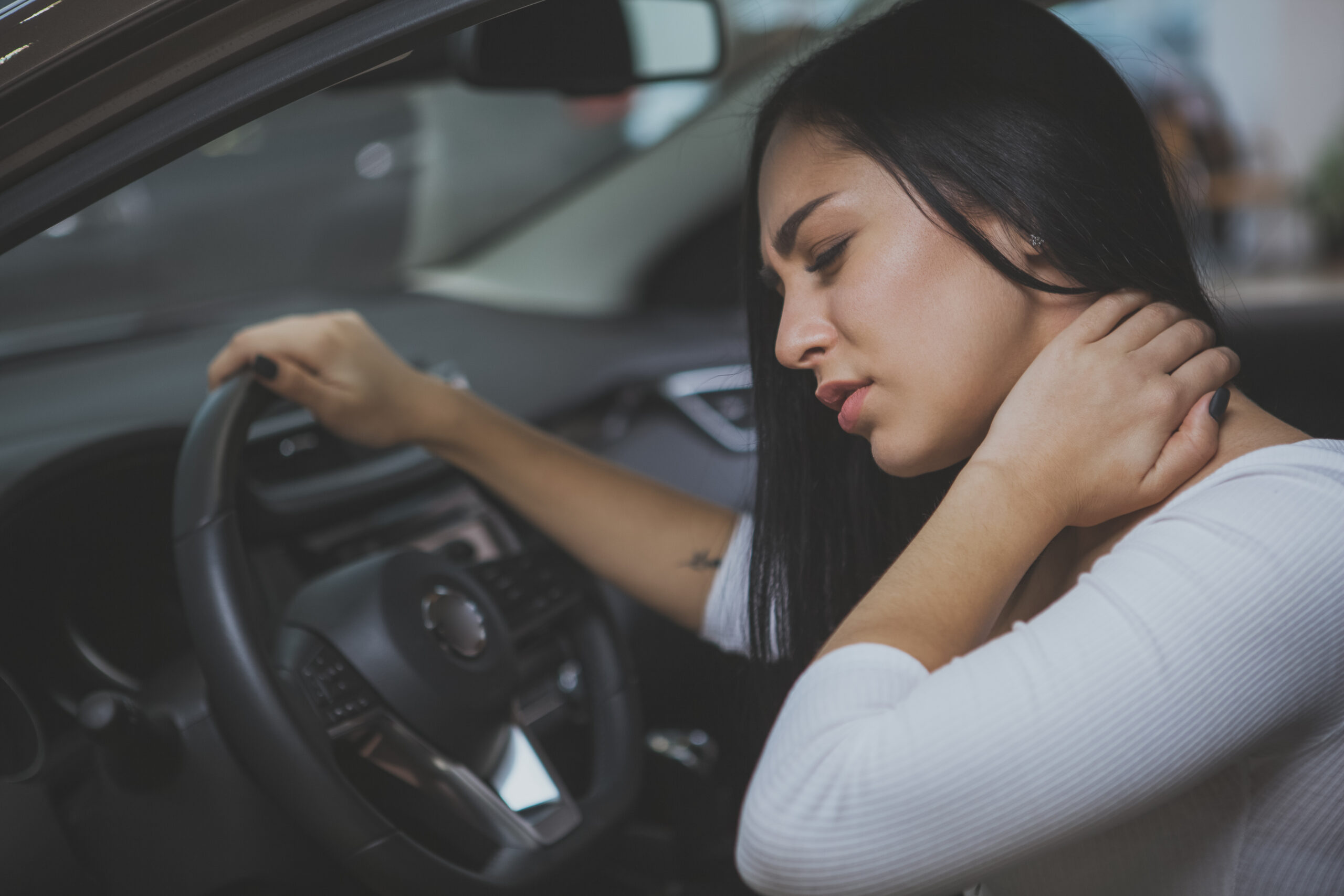 Person with whiplash neck injury from car accident needing treatment in Salinas